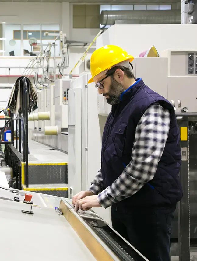 focused-male-engineer-glasses-operating-machine
